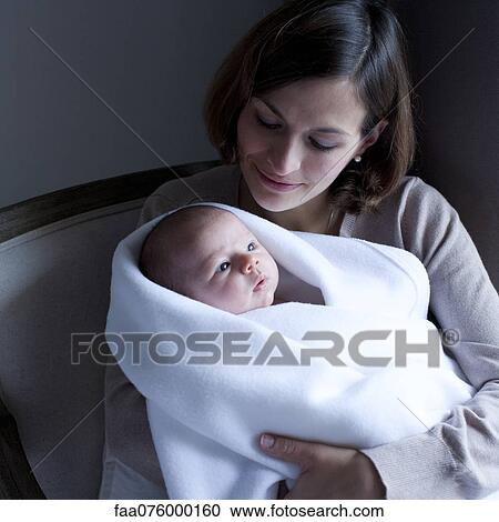 Woman holding newborn baby View Large Photo Image Stock Image - Woman holding newborn baby. Fotosearch