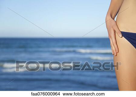Picture - Woman in bikini bottom, cropped. Fotosearch