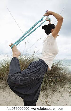 Woman in Natarajasana pose on beach, side view View Large Photo Image Stock Image - Woman in Natarajasana pose on beach, side view. Fotosearch