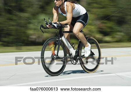Stock Image - Woman riding road bike, cropped. Fotosearch
