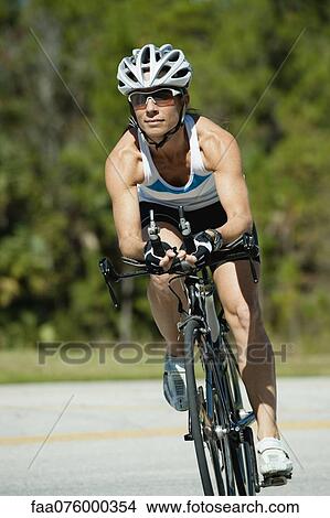 Woman riding road bike, portrait View Large Photo Image Picture - Woman riding road bike, portrait. Fotosearch