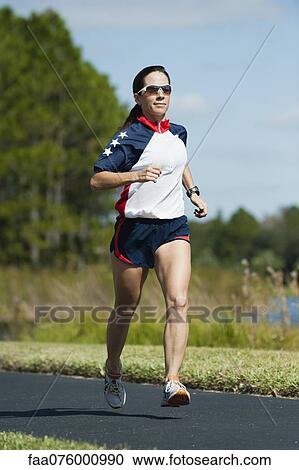 Stock Image - Woman running, portrait. Fotosearch