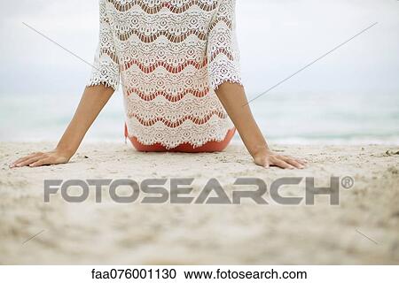 Woman sitting on beach, rear view View Large Photo Image Stock Image - Woman sitting on beach, rear view. Fotosearch