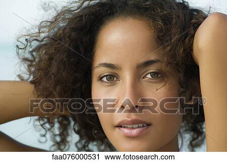 Woman with hands in hair, portrait View Large Photo Image Stock Image - Woman with hands in hair, portrait. Fotosearch