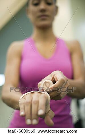 Woman wrapping hand with bandage, low angle view View Large Photo Image Stock Photo - Woman wrapping hand with bandage, low angle view. Fotosearch