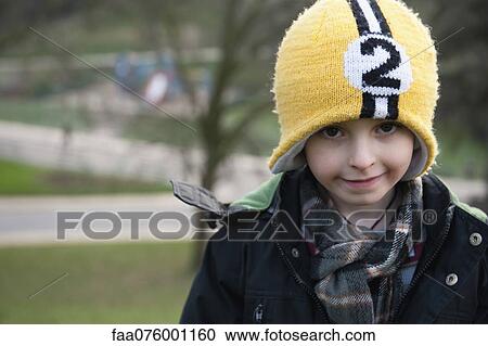 Stock Image - Young boy outdoors, portrait. Fotosearch