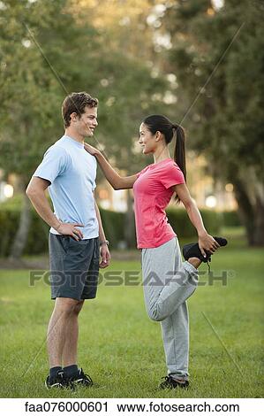 Stock Image - Young couple exercising outdoors. Fotosearch