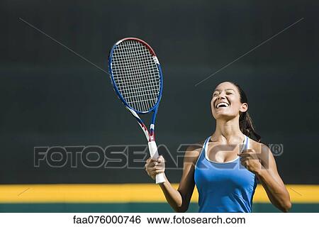 Stock Photograph - Young female tennis player cheering, portrait. Fotosearch