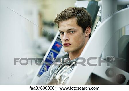 Young man in weight room View Large Photo Image Stock Image - Young man in weight room. Fotosearch