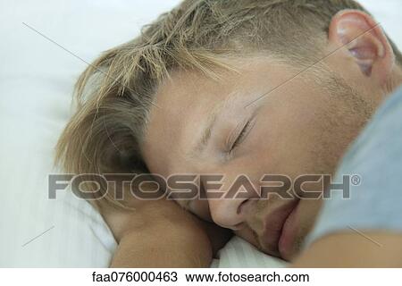 Stock Image - Young man sleeping, cropped. Fotosearch