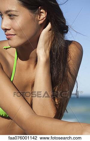 Young woman in bikini sunbathing, cropped View Large Photo Image Stock Image - Young woman in bikini sunbathing, cropped. Fotosearch
