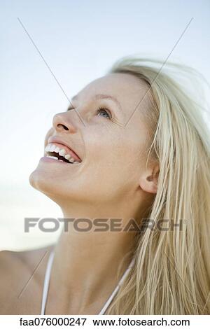 Stock Photo - Young woman laughing outdoors. Fotosearch