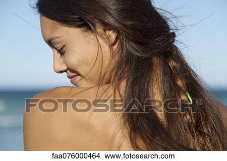 Picture - Young woman outdoors, over the shoulder view. Fotosearch