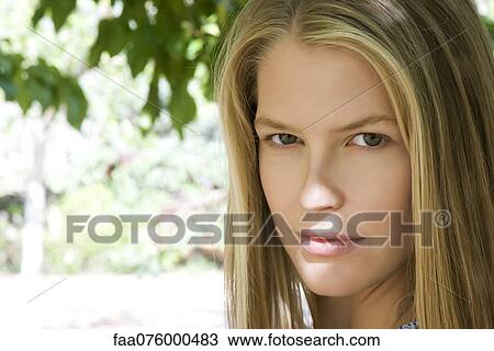 Stock Image - Young woman outdoors, portrait. Fotosearch