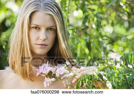 Stock Photo - Young woman outdoors, portrait. Fotosearch