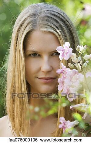 Stock Photograph - Young woman outdoors, portrait. Fotosearch