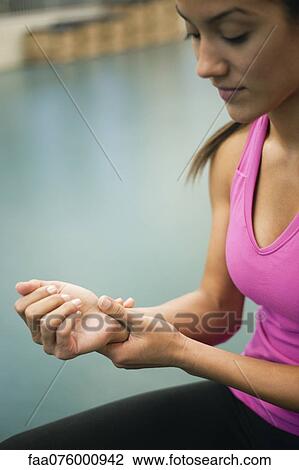 Young woman rubbing wrist View Large Photo Image Stock Image - Young woman rubbing wrist. Fotosearch