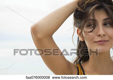 Young woman with hands in hair, cropped View Large Photo Image Stock Photo - Young woman with hands in hair, cropped. Fotosearch
