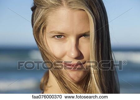 Stock Image - Young woman with tousled hair, portrait. Fotosearch