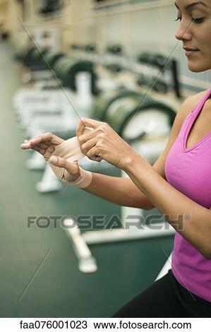 Young woman wrapping hand with bandage, cropped View Large Photo Image Stock Image - Young woman wrapping hand with bandage, cropped. Fotosearch