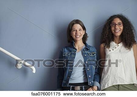 Young women standing together in hallway View Large Photo Image Stock Photography - Young women standing together in hallway. Fotosearch