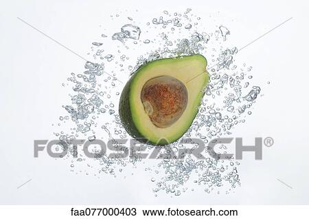 Avocado half submerged in sparkling water View Large Photo Image Stock Image - Avocado half submerged in sparkling water. Fotosearch