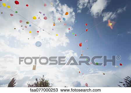 Stock Image - Balloons floating toward sky. Fotosearch