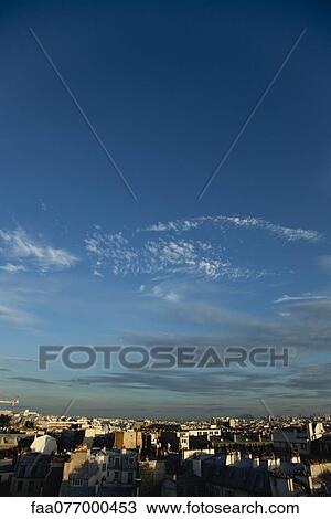 Stock Image - Blue sky over rooftops, Paris, France. Fotosearch