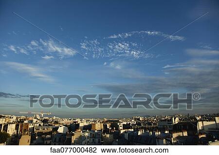 Stock Image - Blue sky over rooftops, Paris, France. Fotosearch