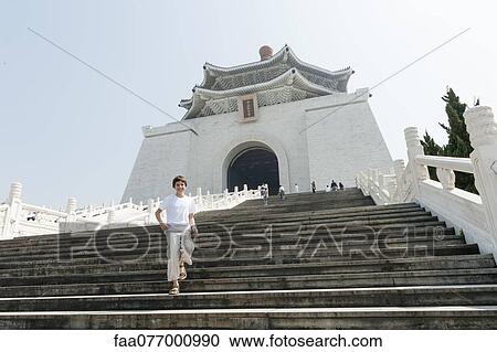 Stock Image - Boy going down steps of Chiang Kai-shek Memorial Hall, Taipei, Taiwan. Fotosearch