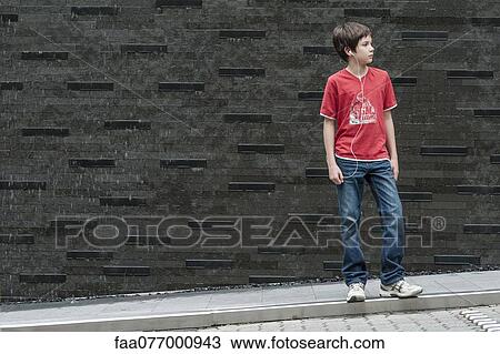Stock Image - Boy listening to music with earphones. Fotosearch
