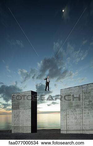 Picture - Businessman walking on tightrope. Fotosearch