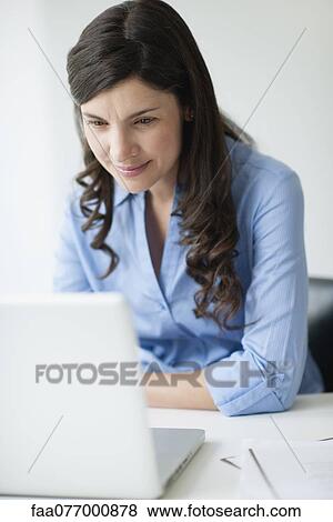 Businesswoman using laptop computer View Large Photo Image Stock Photo - Businesswoman using laptop computer. Fotosearch