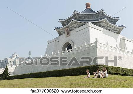 Children sitting on grass by Chiang Kai-shek Memorial Hall, Taipei, Taiwan View Large Photo Image Stock Image - Children sitting on grass by Chiang Kai-shek Memorial Hall, Taipei, Taiwan. Fotosearch