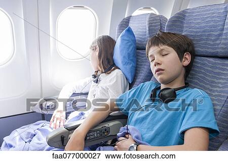 Stock Photo - Children sleeping on airplane. Fotosearch