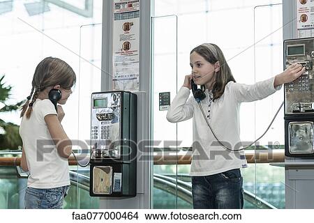 Picture - Children using payphones. Fotosearch