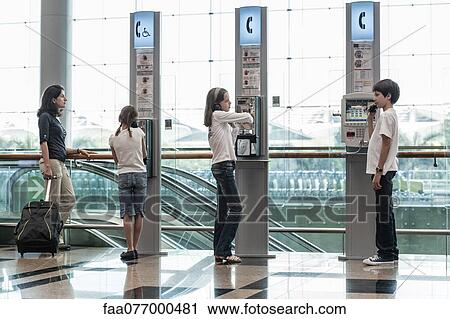 Stock Image - Children using payphones. Fotosearch