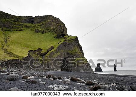 Stock Image - Columnar basalt cave and black sand, Vik Beach, Vik, Iceland. Fotosearch