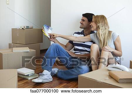Couple discussing color swatches in new house View Large Photo Image Stock Image - Couple discussing color swatches in new house. Fotosearch