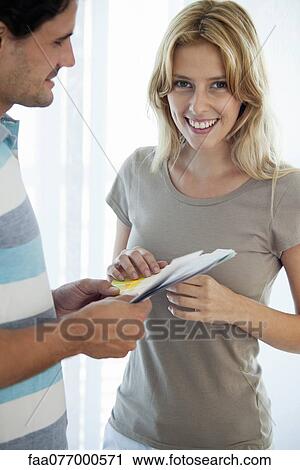 Stock Image - Couple discussing color swatches. Fotosearch