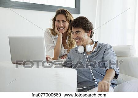 Couple looking at laptop computer View Large Photo Image Stock Image - Couple looking at laptop computer. Fotosearch
