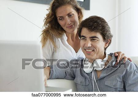 Stock Photography - Couple looking at laptop computer. Fotosearch