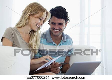Picture - Couple paying bill online. Fotosearch