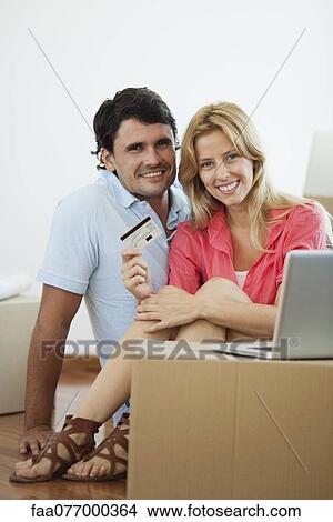 Picture - Couple shopping online for their new home. Fotosearch