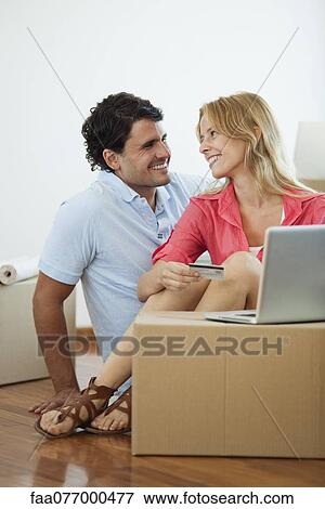 Couple shopping online for their new home View Large Photo Image Stock Photo - Couple shopping online for their new home. Fotosearch