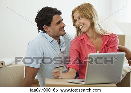 Stock Photography - Couple shopping online for their new home. Fotosearch