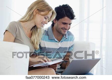Couple shopping online with laptop computer View Large Photo Image Stock Image - Couple shopping online with laptop computer. Fotosearch