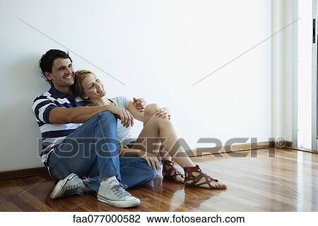 Couple sitting on hardwood floor View Large Photo Image Stock Image - Couple sitting on hardwood floor. Fotosearch