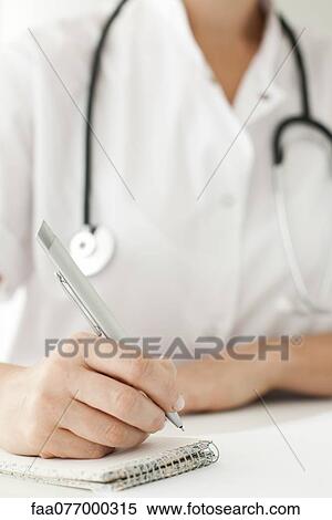 Doctor writing notes on notepad, cropped View Large Photo Image Stock Photography - Doctor writing notes on notepad, cropped. Fotosearch