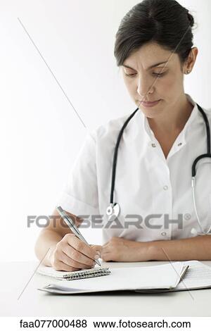 Stock Photo - Doctor writing notes. Fotosearch